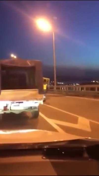 Four people dressed as a bus try to cross a vehicle only bridge