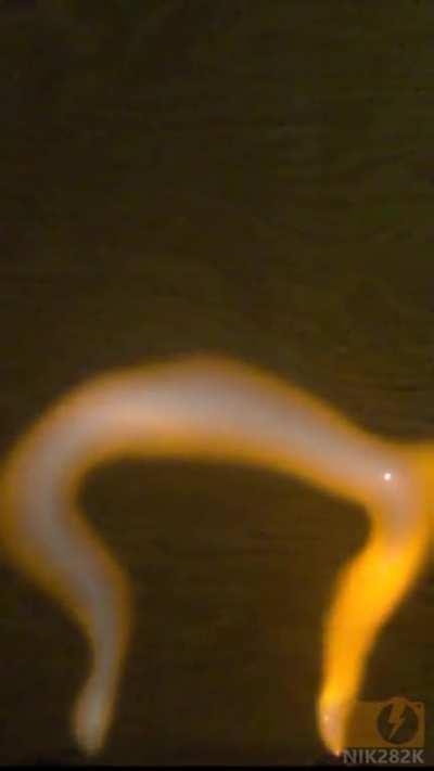 8kV 200mA 60Hz AC arc, filmed at 5000fps playback 30fps. More info in comments.