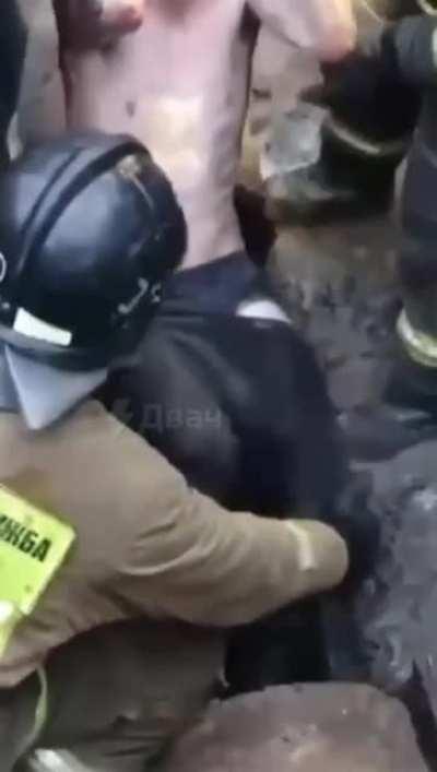 A man is stuck in a sewer pipe.