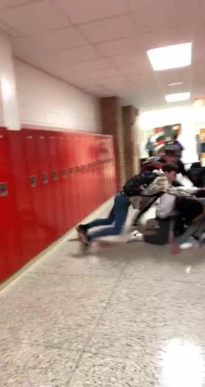 not sure about context, but solid grey hoodie and white hoodie started fighting and their friends jumped in to break it up