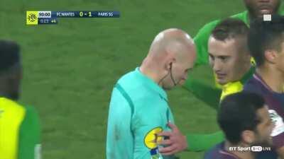 Football referee ridiculously abuses his powers by sending off a player after he was accidentally tripped by him kicks out at him.