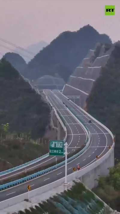 Highways piercing right through high and mighty mountains. Guizhou province in China.