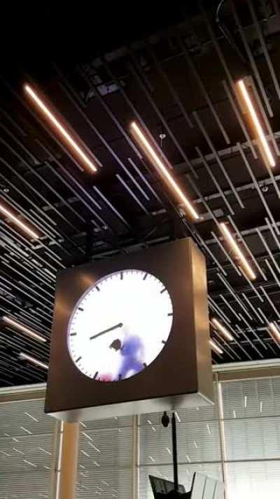 Amsterdam Schiphol airport has a clock where a worker inside paints the time.
