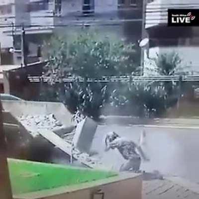 Pushing a heavy wheelbarrow up a plank of the wood..