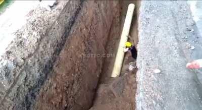 Ground caves in on pipe worker