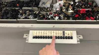 This is a Remington / Sperry Rand Kard Veyer, an automatic 12-shelf rotating cabinet. Originally used in a military base, it was used for storing punch cards. This thing was built in the mid 60s and is the coolest shelf ever!