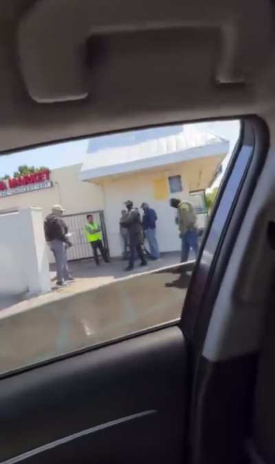 ICE agents aim weapon at person filming in car Santa Ana, CA