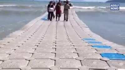 A floating walkway on the sea.