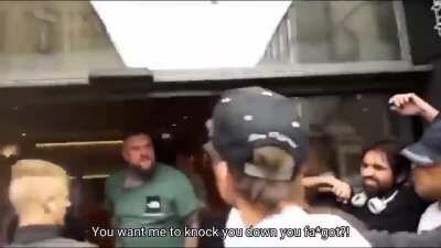 Vegans trying to stop a Viking from entering McDonald's