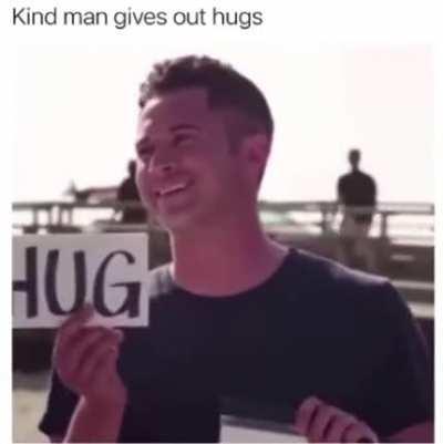 Kind man gives out Hugs
