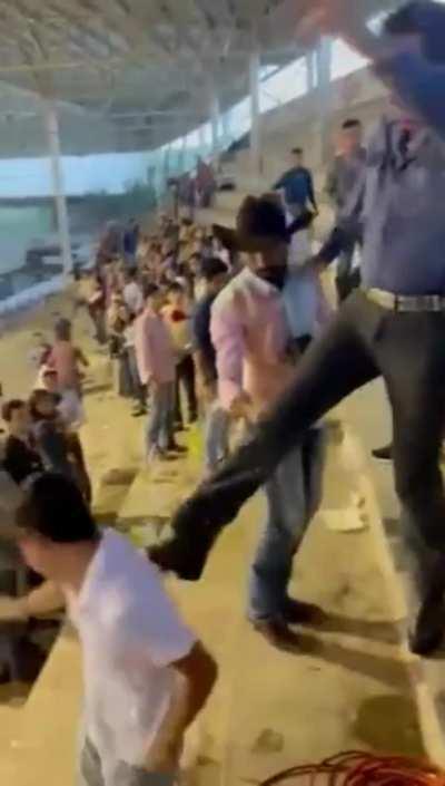 Kicking a guy down the steps.