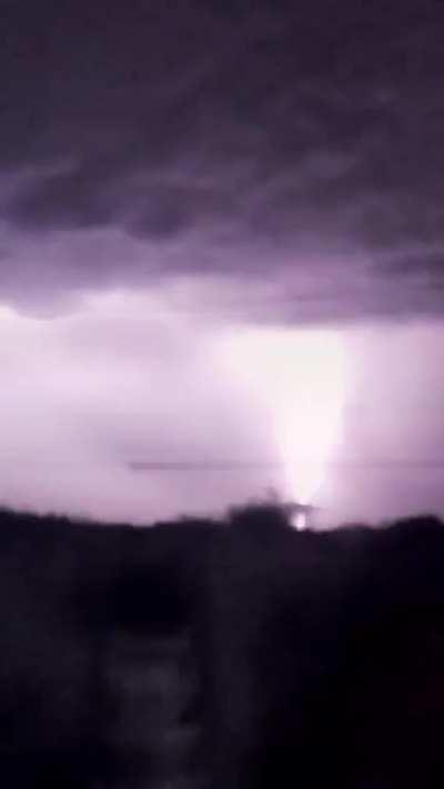 An abnormally long lightning strike and something falling out of the sky