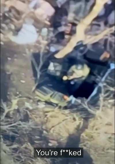 A Russian soldier appeals to God for protection. At the same time, a Ukrainian Army drone is hovering over his trench, ready to drop grenades.