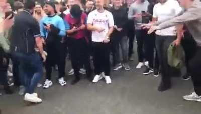 Villa fans celebrating the win outside Old Trafford