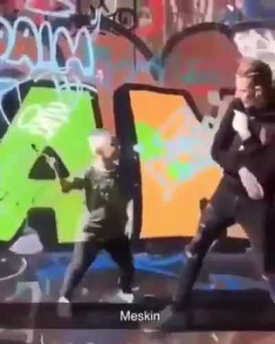 Kid tries to attack someone with a hammer