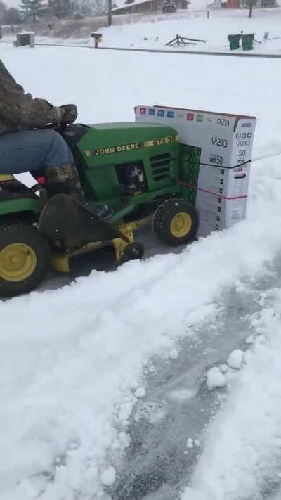 Plowing snow with a cardboard TV box