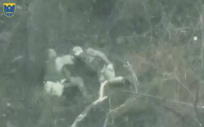 Two russians in a firefight with soldiers of the 118th separate territorial defense brigade in Luhansk region. Taking cover on a slope, one raises his head just a bit too high and is hit.