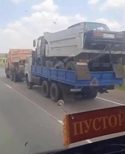 Truck carrying a truck pulling a truck carrying a truck carrying a car