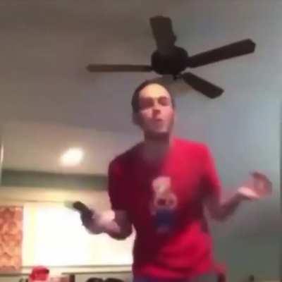 Guy flexing and waving around gun , ends up pulling the trigger