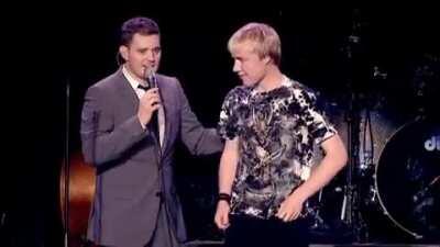 As soon as the kid starts singing he goes wild!