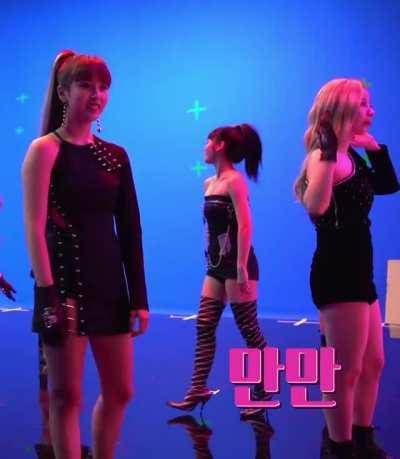 Mina - high ponytail, blonde highlights, short black dress, squats, fancy behind the scenes