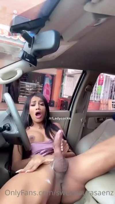 She strokes her massive cock and cums in her car