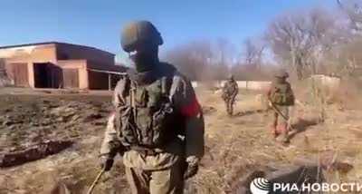 Russian cameramen is walking on mine field before the demining sapper.