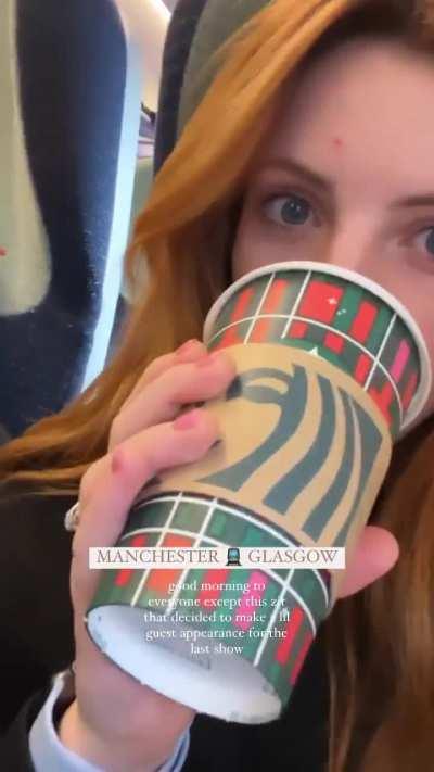 Having a sip of her drink during her UK travels (November 2023)