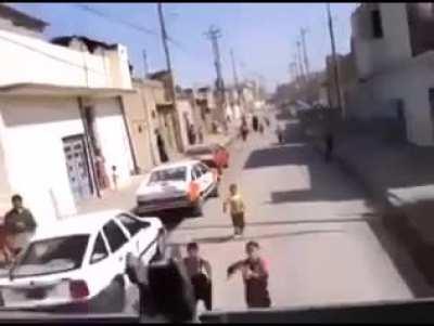 U.S soldier taunts children with water.