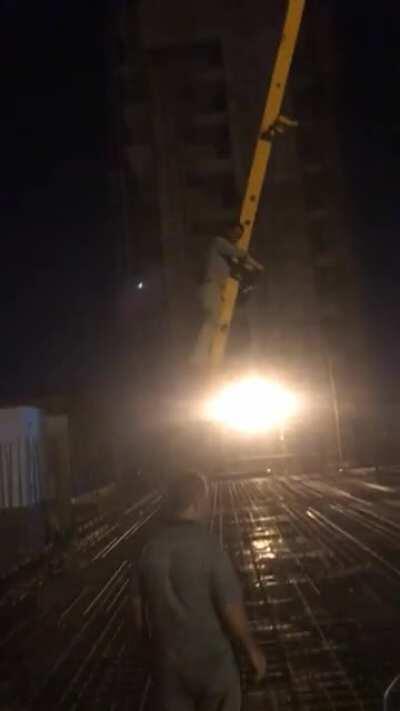 Pump operator lifts himself up to the top floor using the hose. About 4 stories high.