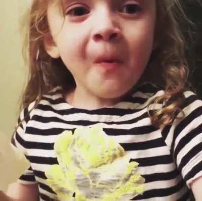 This little girl pretending to enjoy her mum's cooking.