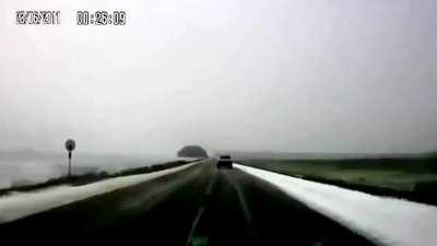 Car loses control on snow and overturns