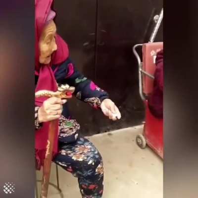 A 107-year-old mother giving her 84-year-old daughter some candy