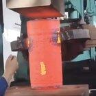 Compressing a block of iron with a hydraulic press