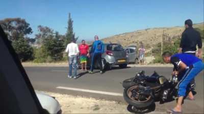 Car Skids Causing Biker to Crash