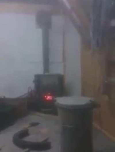 Drunk guys open the Gates of Hell putting a spray can into a wood stove.