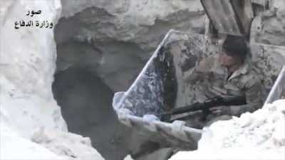 Soldier lowered into a tunnel in a excavator to clear ISIS militants.