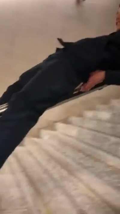 Sliding down public stairways