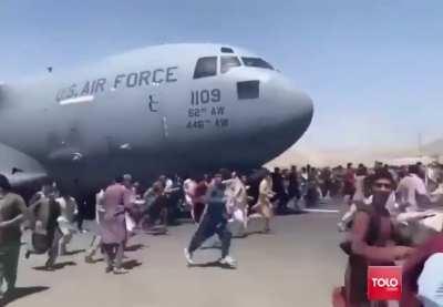US military plane trying to leave Kabul with people hanging to the wheels