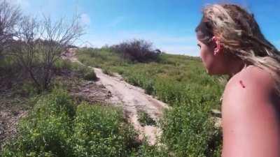 Girl crashes into cactus wearing a tank top and shorts