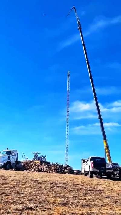 Crane drops roughly 100-ft section of a guyed tower. Guy on the tower was lucky, This could end it horribly worse