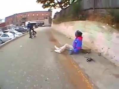 BMX rider tries to jump over a homeless person.