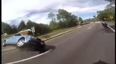 Biker VS Car road rage incident results in hectic car crash.
