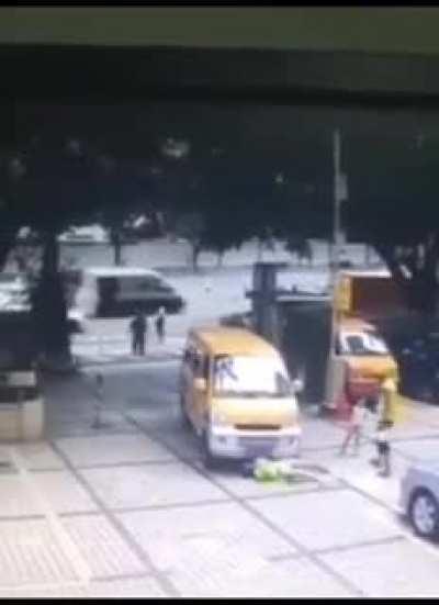 Lady trying to push a kid in front of a car and then acting like she got hit.