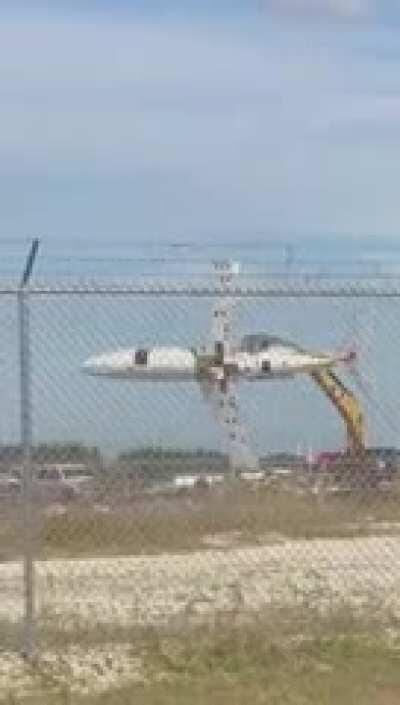 crane moving an airplane like a toy