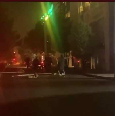 Iranian woman took off her hijab and walked toward the Islamic morality police.