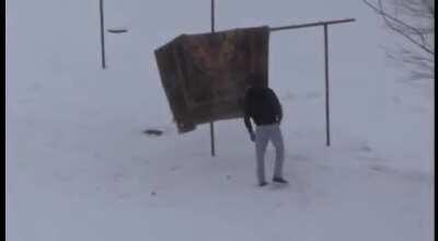 Russian man beating up his carpet (warning: violence)