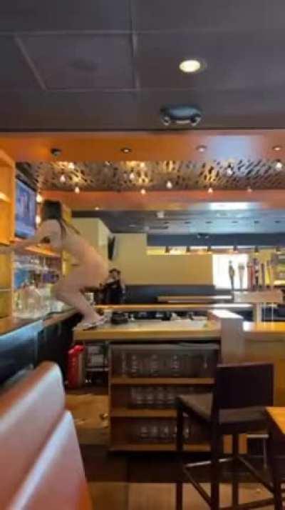 To clear the shelves of a local bar high and naked before getting arrested