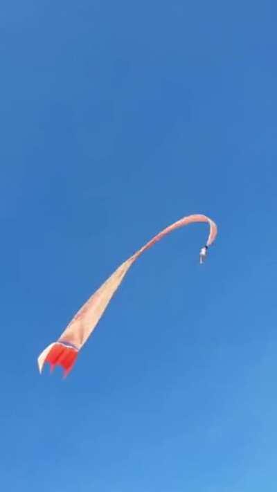 With a huge kite and strong wind