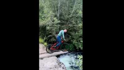 to balance a bicycle at the edge of board (over a river)